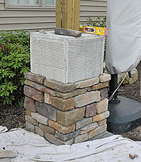 Outdoor bar column being veneered