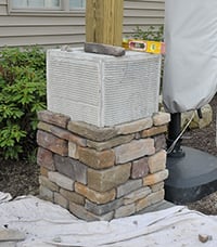Outdoor bar column being veneered